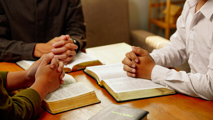 Christian Bible Study Concepts. Christian group or family prayer together with a holy bible on a...