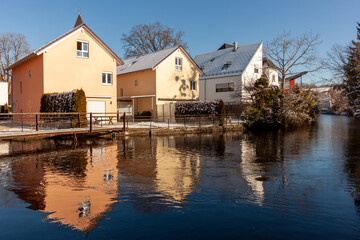 Fototapeta na wymiar Houses by the river Wolfegger Ach in Baienfurt, Baden Wuerttemberg