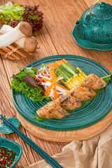 Vietnamese spring rolls with vegetables on a green plate with delicious dipping sauce