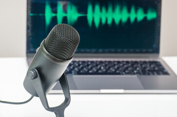 Podcast equipment: microphone and laptop