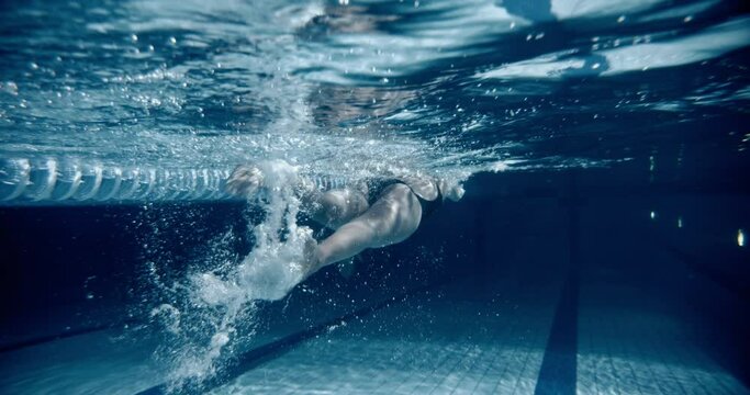 Woman swimming front crawl in a pool