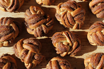 Cinnamon Buns. Freshly Baked  Buttery Cinnamon Buns on Wooden Board. Bakery Pastry.
