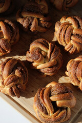 Cinnamon Buns Top View on Wooden Board. Freshly Baked Desserts for Breakfast, Holidays. Buttery Pastry. 
