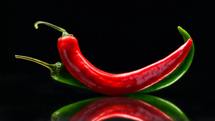 red and green chili peppers on a black background