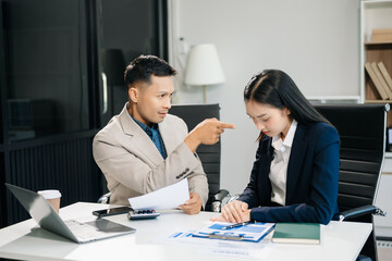 Furious two Asian businesspeople arguing strongly after making a mistake at work in modern office
