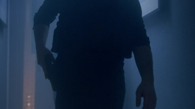 Two policemen are entering the house at the scene of the crime.