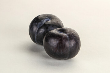 Two ripe sweet black plums