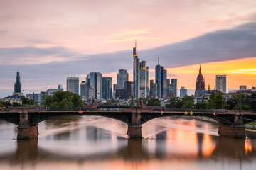 View from a bridge over the River Main to a skyline in the financial district in the background as...