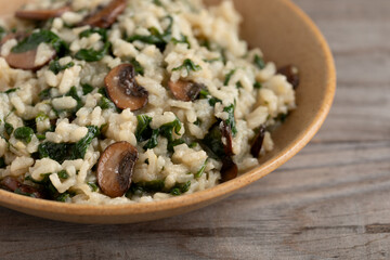 Close up view of homemade lemon risotto with spinach and portobello mushroom. Healthy lifestyle...