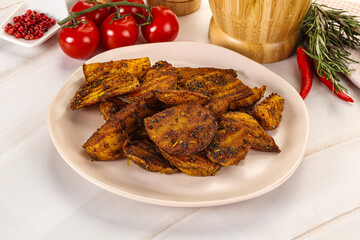 Golden baked potato Idaho with spices
