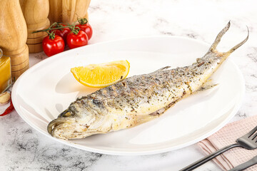 Grilled sea bass fish served lemon