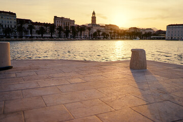 Concrete bollard for mooring of ships at pier. Landscape with sea wharf. Split, Croatia.