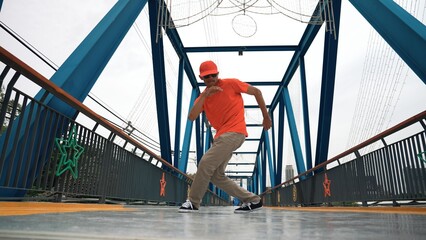 Skilled asian hipster perform footstep at bridge with low angle camera while wearing stylish cloth....