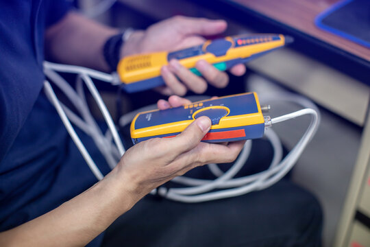 Network cable tester. Testing structured cabling using qualified cable performance tester. UTP cable with RJ45 jack checking with digital cable tools.