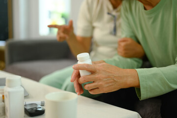 Close up shot of elderly man taking prescription medicine at home. Healthcare concept