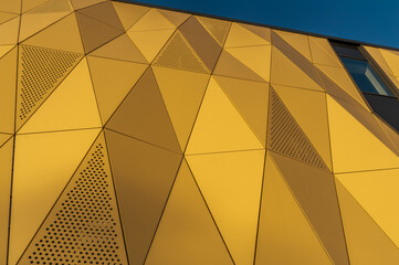 Facade of modern office building made of many triangles