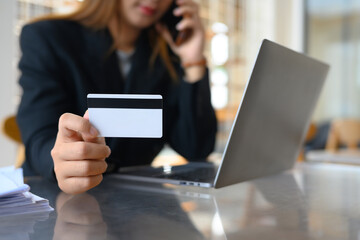 Select focus on woman holding credit card. Transactions, shopping online and finance concept