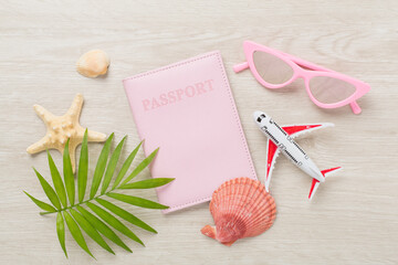 Bright flat lay with travel accessories on wooden background, top view