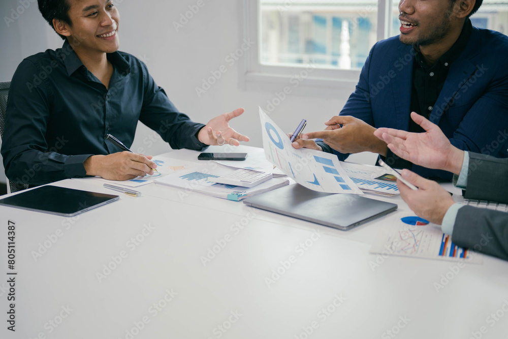 Poster three men are sitting at a table with papers and a laptop