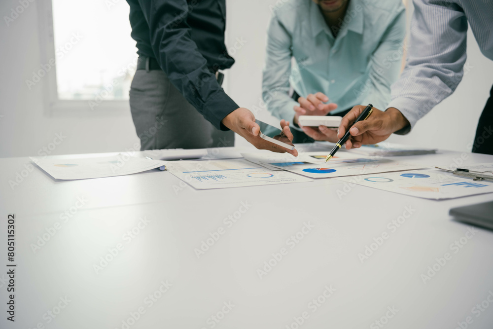 Poster three men are sitting at a table with papers and a cell phone