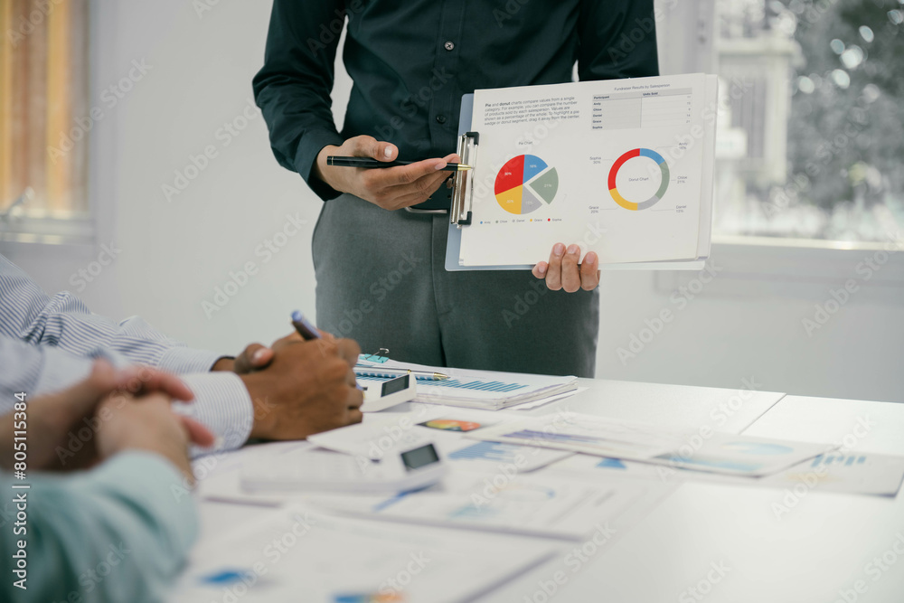 Poster a man is standing in front of a group of people and holding a presentation slide