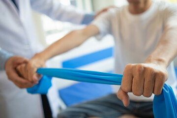 doctor is examining muscle injury and using elastic bands test injury and also help with physical therapy strengthen muscles because physical therapy will help strengthen muscles and help blood flow.