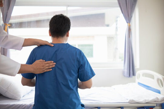 man was admitted for treatment of muscle pain in back of his shoulder due to working hard and causing muscle inflammation. doctor is treating man muscle pain in his back and shoulders due to overwork.