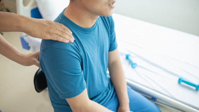 man was admitted for treatment of muscle pain in back of his shoulder due to working hard and causing muscle inflammation. doctor is treating man muscle pain in his back and shoulders due to overwork.