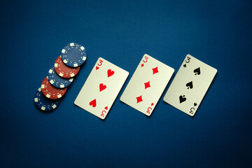 Luck in a game of poker with a winning combination of three of a kind or set. Playing cards and...