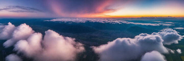 Aerial view of beautiful sunrise over the clouds. Panoramic image