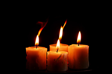 Burning candles on a black background