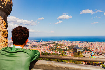 Person overlooking Spanish city from roof 