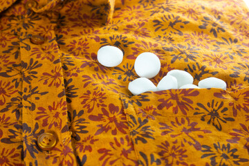 White naphthalene balls on cloth.