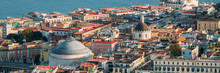 Naples, Italy. Top View Cityscape Skyline With Famous Landmarks And Part Of Gulf Of Naples In Sunny Day. Many Old Churches And Temples.