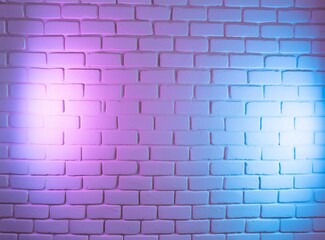 Purple neon light on brick wall background