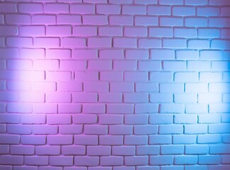 Fototapeta premium Purple neon light on brick wall background