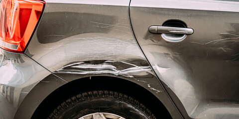 Broken Scratched Rear Fender Car. Scratched With Deep Damage To Paint. Close Up