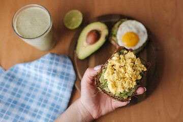 Top view of avocado toast with egg on top. Healthy and tasty breakfast. Green smoothie