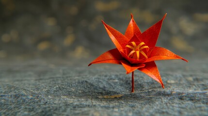   Close-up of a red origami flower against a gray backdrop, featuring a yellow bloom at its core - Powered by Adobe