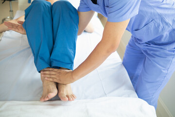 Doctors are examining patient muscle injuries and doing physical therapy for patient to move...