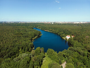 Aerial landscape of lake and Jagdschloss Grunewald in forest on a sunny summer day in Berlin