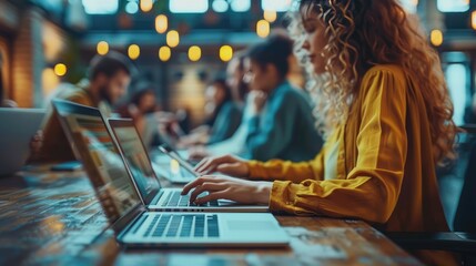 Obraz premium Confident businesswoman working on laptop in a public space.