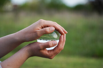 Crystal Sphere. Crystal Sphere, used for meditation, clairvoyance, health, luck and abundance! Hands covering the crystal sphere. Day photo. Crystal sphere in various angles.Various backgrounds. 