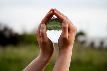 Crystal Sphere. Crystal Sphere, used for meditation, clairvoyance, health, luck and abundance! Hands covering the crystal sphere. Day photo. Crystal sphere in various angles.Various backgrounds. 