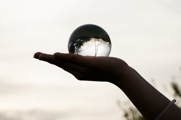 Crystal Sphere. Crystal Sphere, used for meditation, clairvoyance, health, luck and abundance! Hands covering the crystal sphere. Day photo. Crystal sphere in various angles.Various backgrounds. 