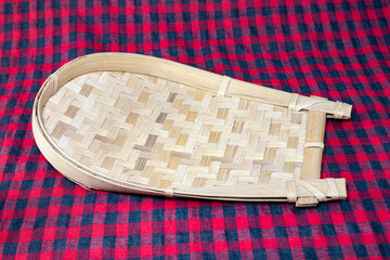Utensil dustpan or kula made of Bamboo for clarifying rice and other grains. Traditional rice cleaner in India and Bangladesh.