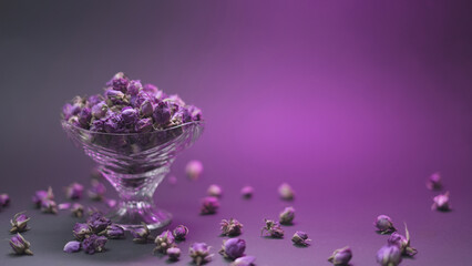 Dried damask rose buds in a crystal bowl, food backdrop