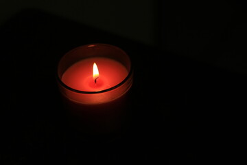 one candle in a dark place for festivals or religions