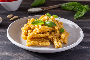 Sicilian pasta with almond and tomatoes pesto. Typical Italian food from Sicily, pasta with red pesto.