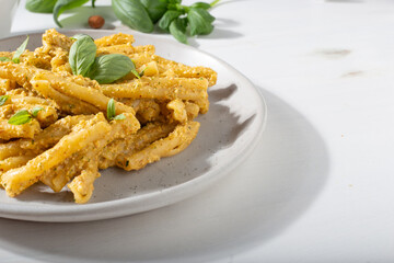 Sicilian pasta with almond and tomatoes pesto. Typical Italian food from Sicily. Food suitable for vegetarians.